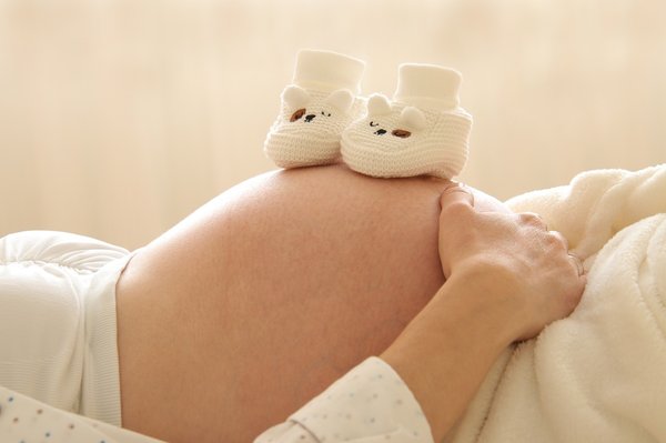 How do UK health guidelines adjust prenatal care for women over 40?
